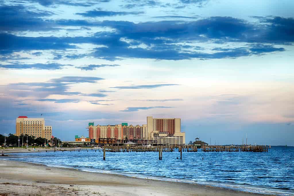 Biloxi, Mississippi, casinos and buildings along Gulf Coast shore at sunset