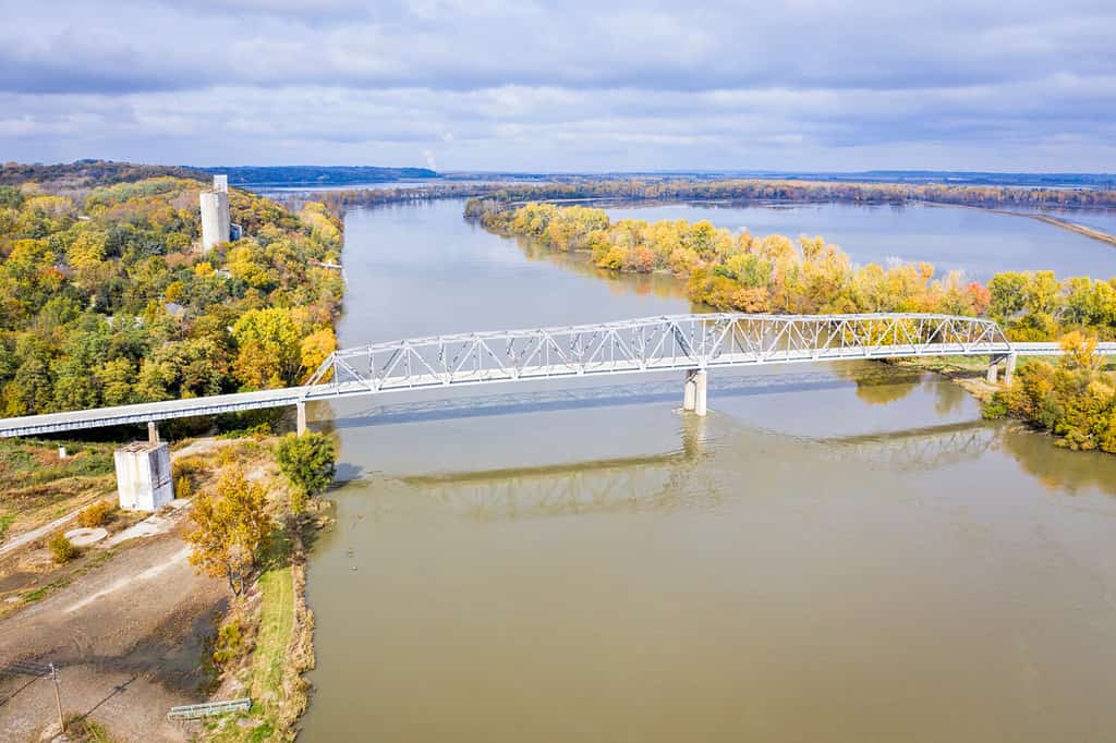 Brownville Bridge over the Missouri River on U.S. Route 136 from Nemaha County, Nebraska, to Atchison County, Missouri, at Brownville, Nebraska, aerial view in fall scenery with flooded river.