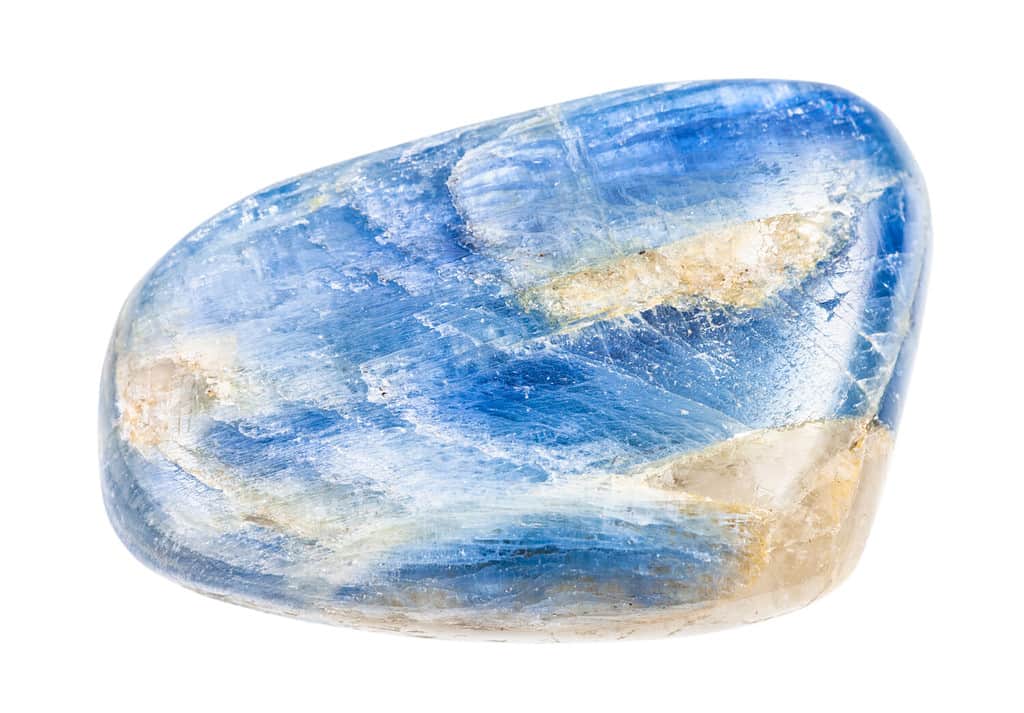 closeup of sample of natural mineral from geological collection - polished Kyanite gem isolated on white background