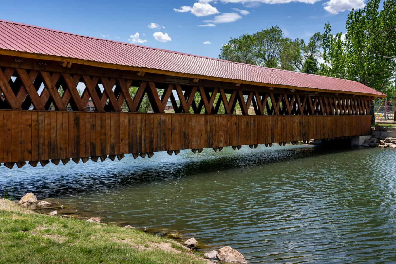 A covered bridge spans a pond in the park at Edgemont, South Dakota.