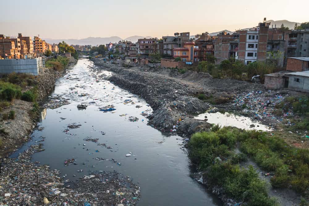 Contaminated river runs through city. waste is discarded river bank. lack of waste collection services. Kathmandu, Nepal, Asia
