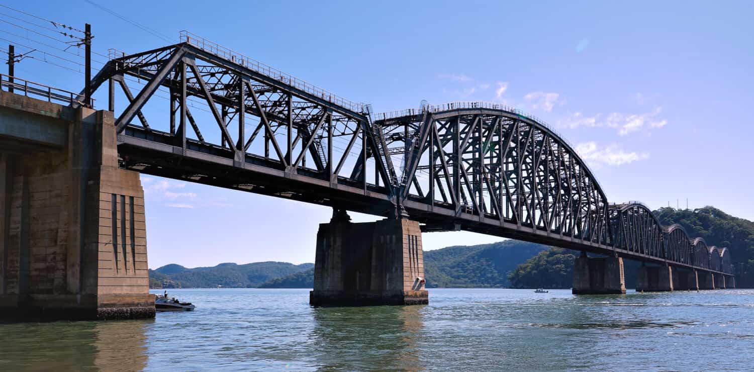 Beautiful Old Iron railway bridge over the sparkling waters of the Hawkesbury River in the NSW central coast region