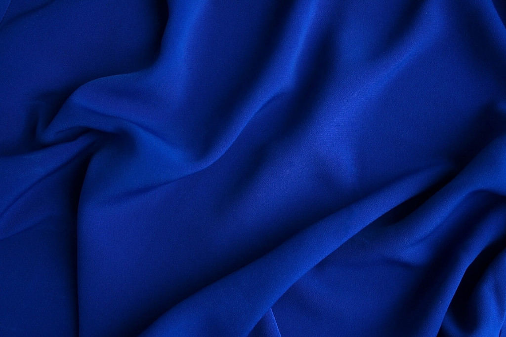The fabric is dark blue. Material background.