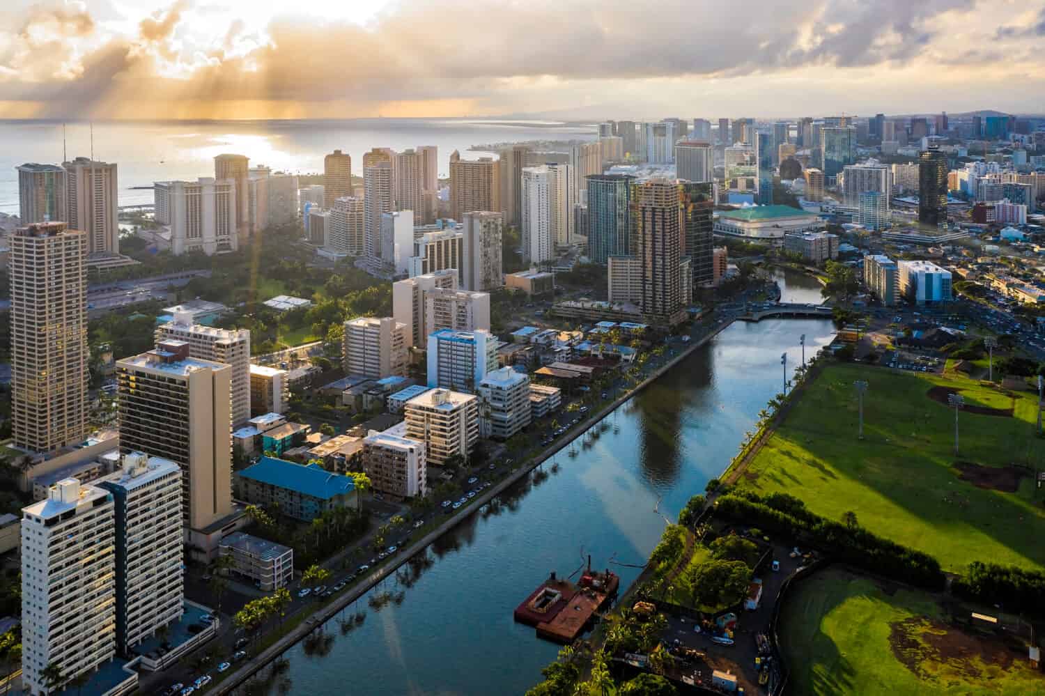 Aerial view of Waikiki district tall buildings by Wai Canal at sunset. Oahu Island, Hawaii