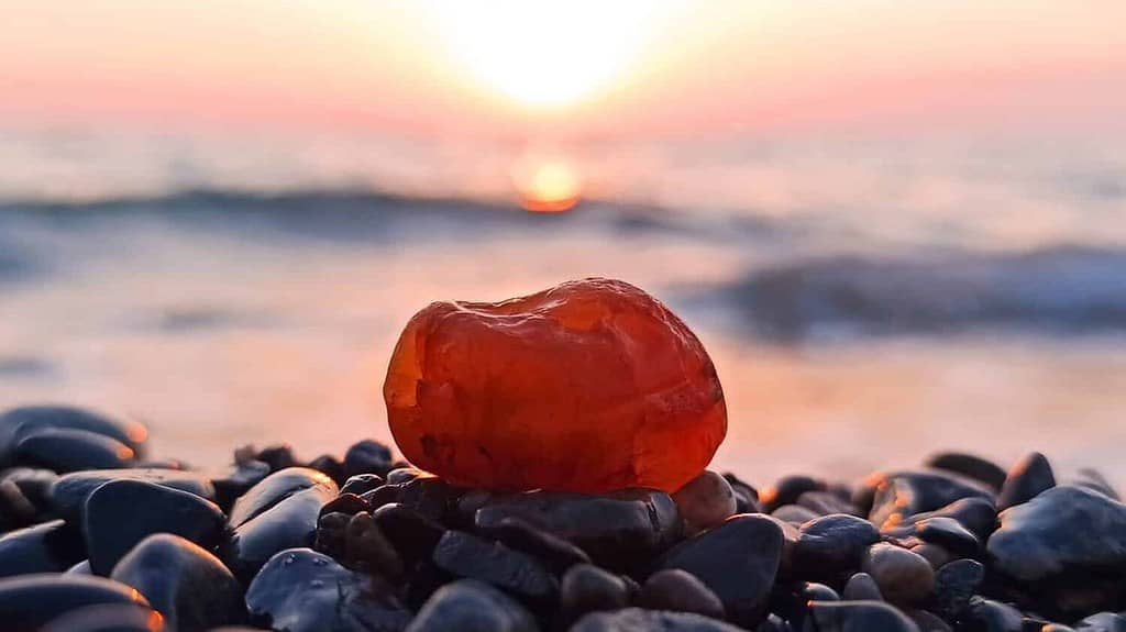 Carnelian Stone on the Seashore Against the Background of Sunset