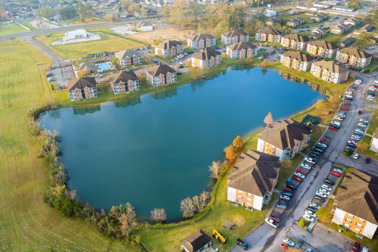 Aerial autumn scene the Denham Springs small town apartment complex near pond in Louisiana US