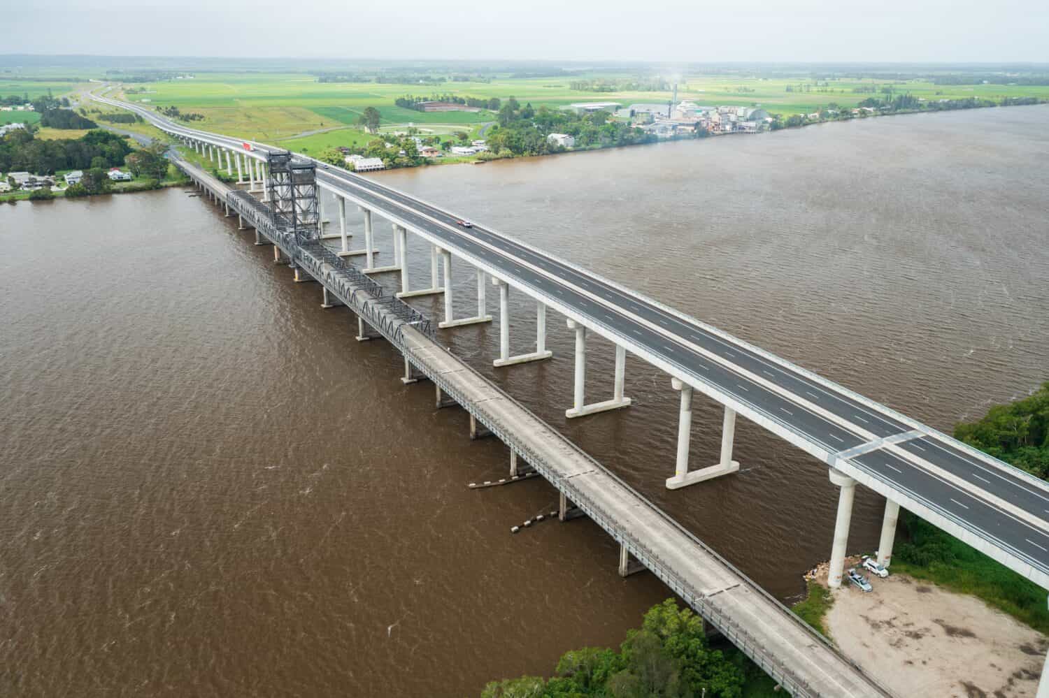 Aerial view of Pacific Highway crossing the Clarence River over the new Harwood Bridge which sits alongside the old bridge at Harwood, NSW, Australia.