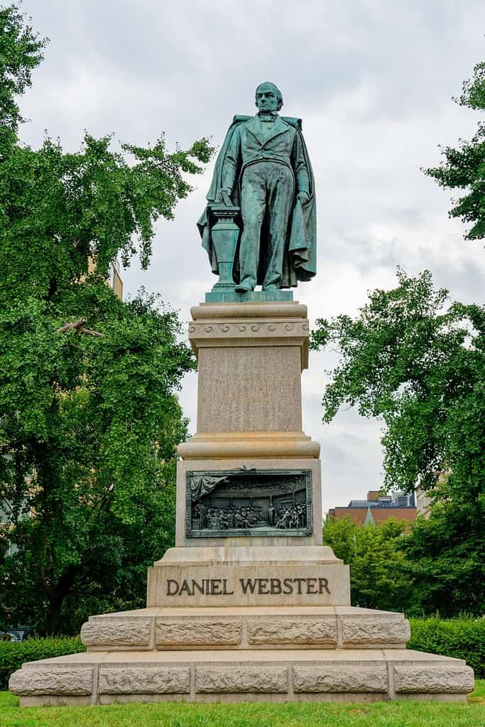 Daniel Webster memorial includes a statue sculpted in 1898 by Gaetano Trentanove. The pedestal dedicated in 1900 includes bronze bas-relief panels.