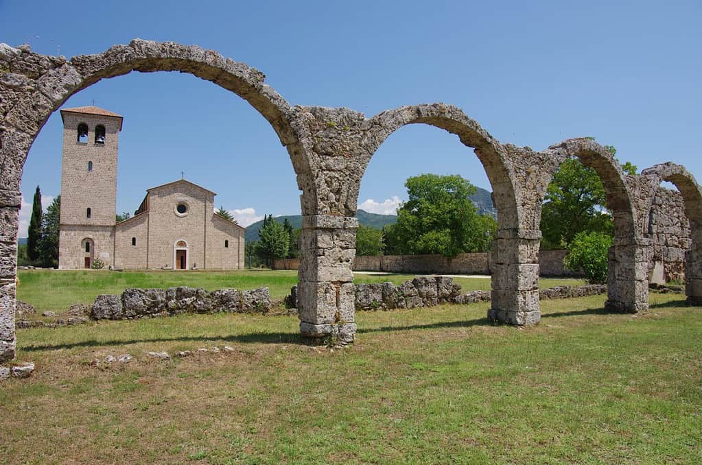 In the foreground the ancient remains of the "Portico del Pellegrino" and in the background the abbey of San Vincenzo al Volturno - Isernia - Molise - Italy