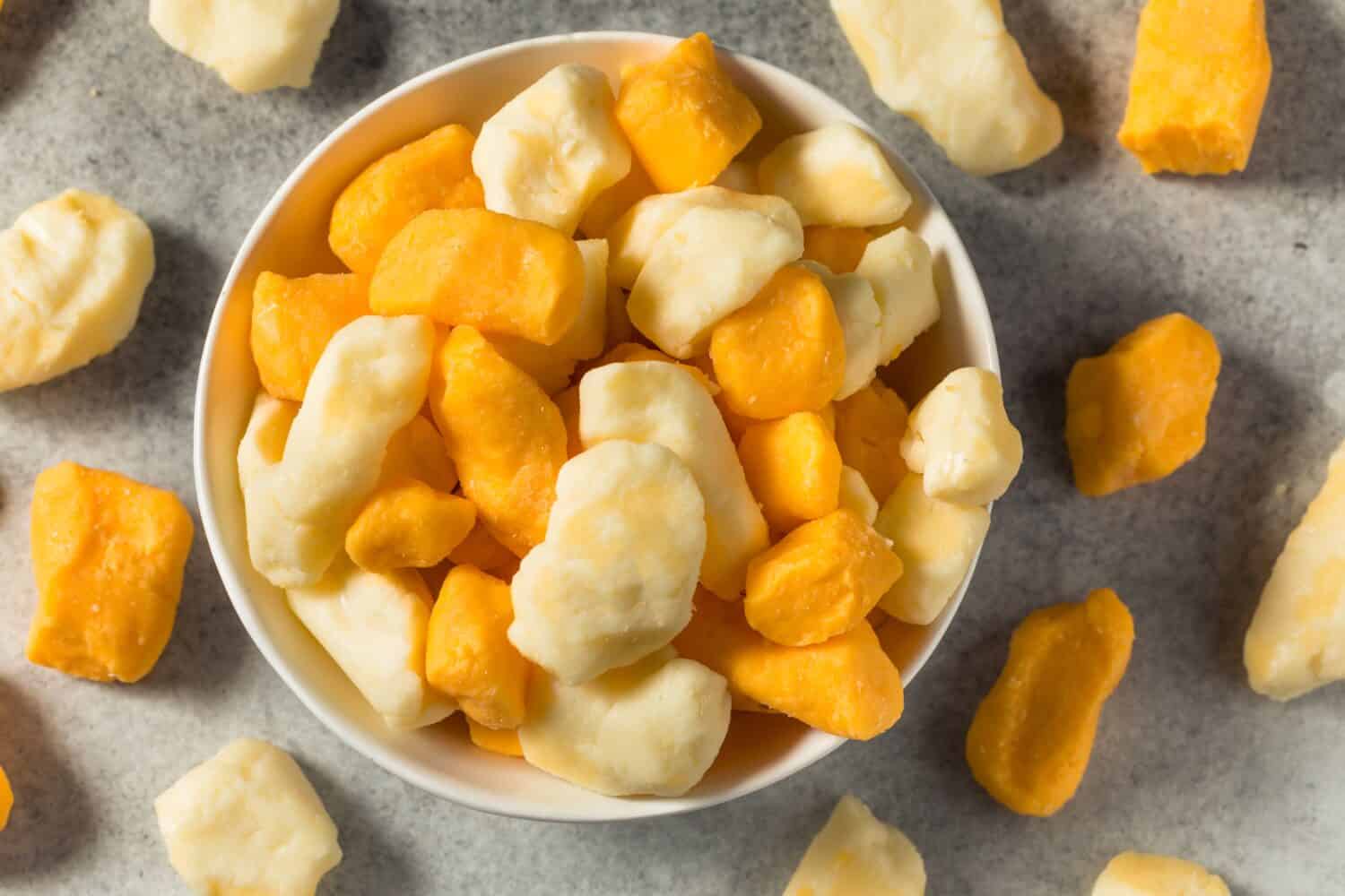 Raw Organic Yellow and White Cheese Curds in a Bowl