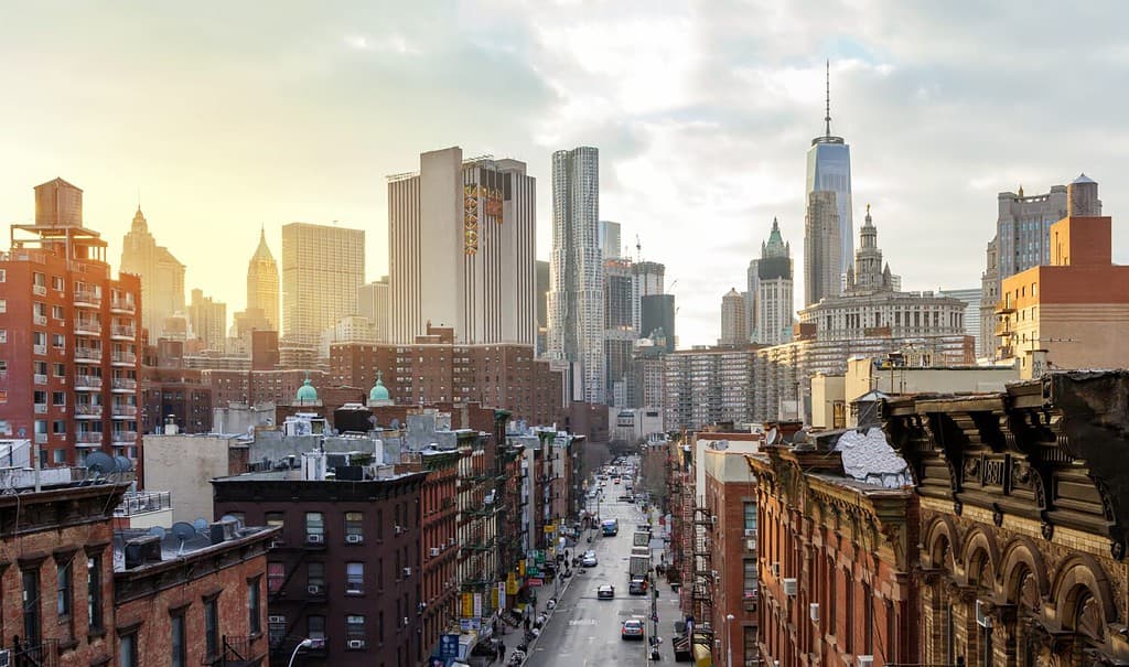 Overhead view of Madison Street in the Chinatown neighborhood of Manhattan with the downtown skyline buildings of New York City in the background