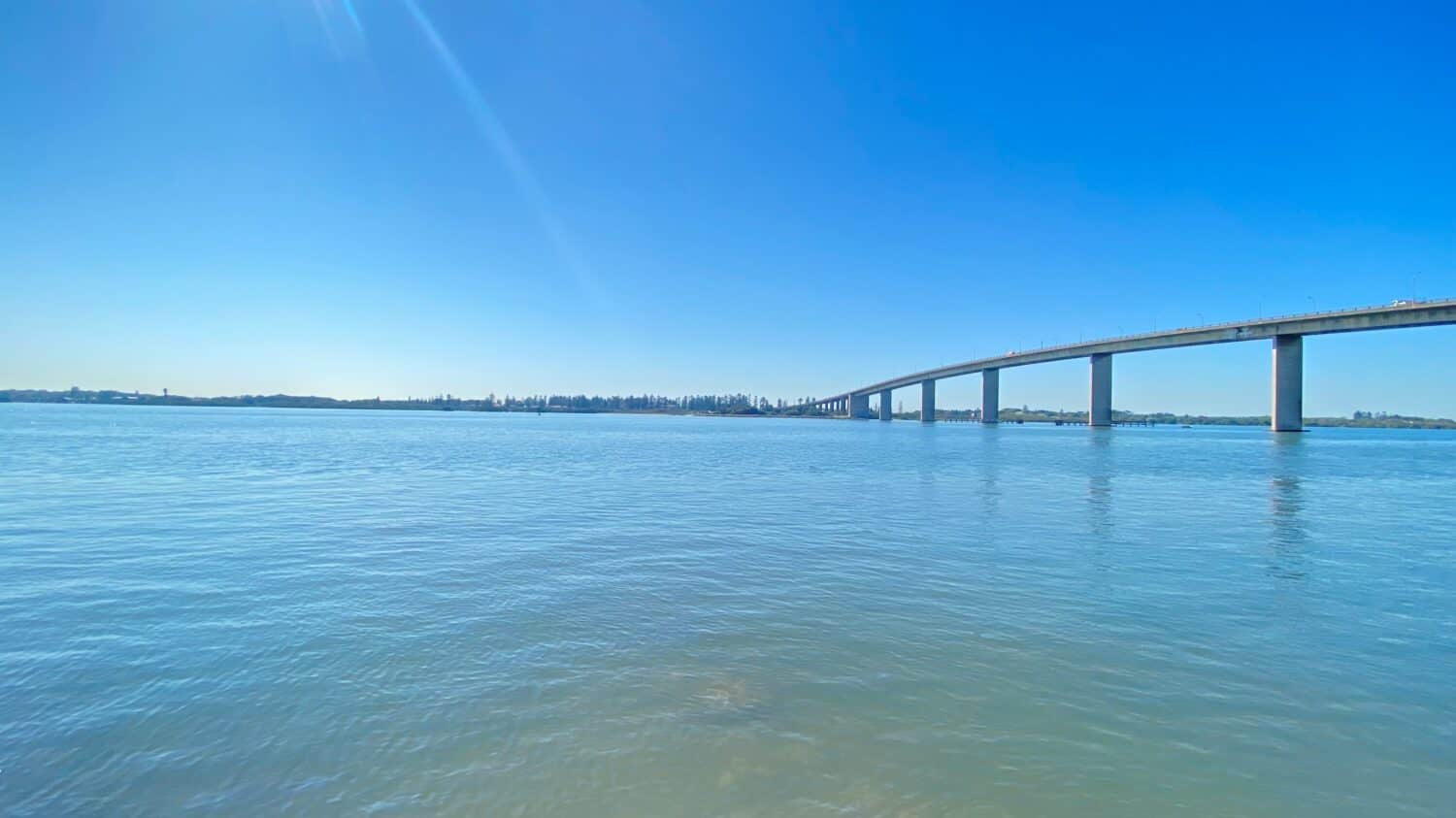 stockton bridge photo in hot summer day with blue sky and blue water.