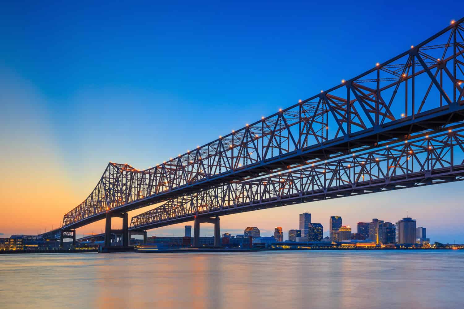 The Crescent City Connection Bridge on the Mississippi river and downtown New Orleans Louisiana