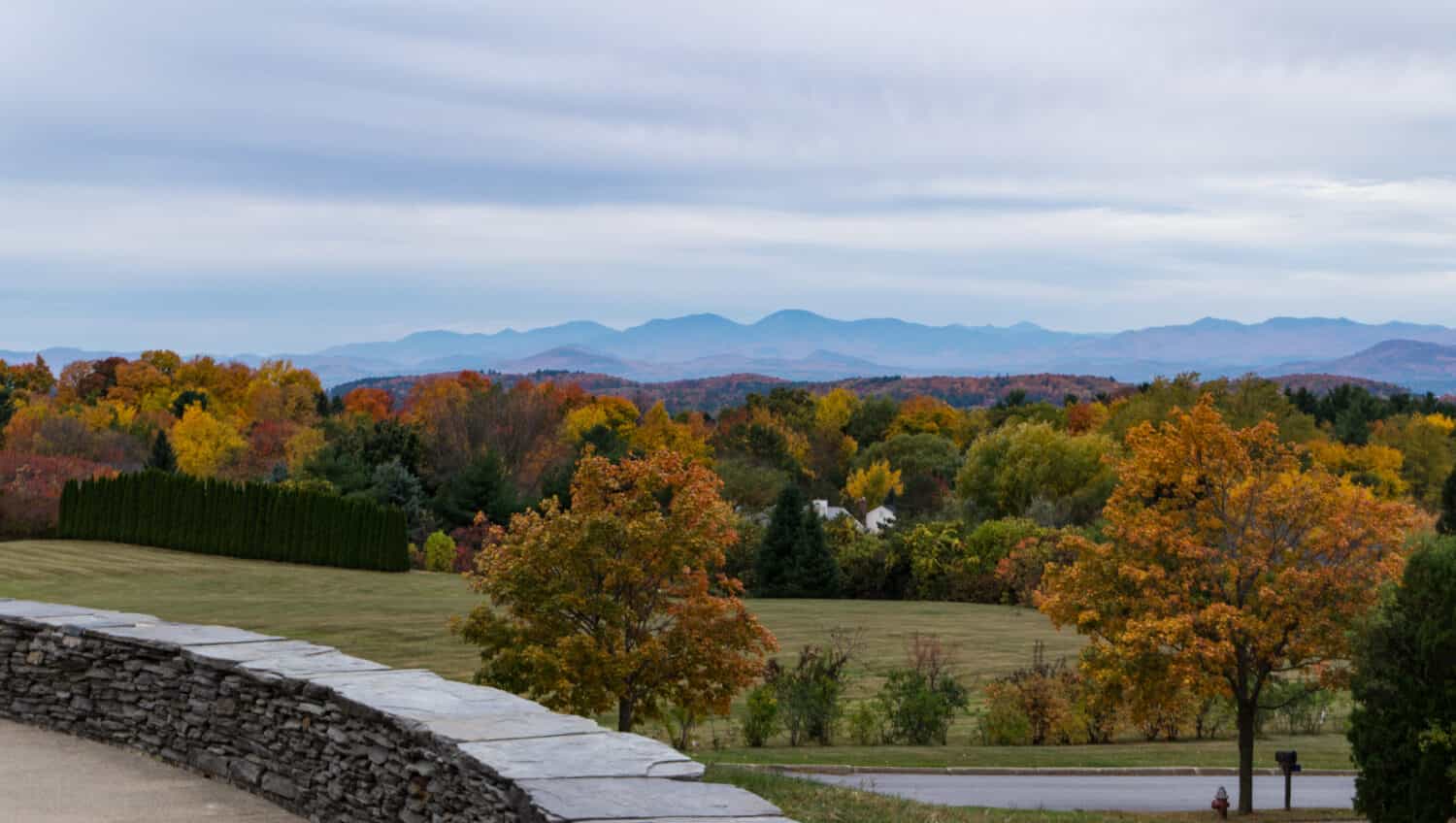 view of fall foliage and Adirondack Mountains in New York from Overlook Park in South Burlington, Vermont