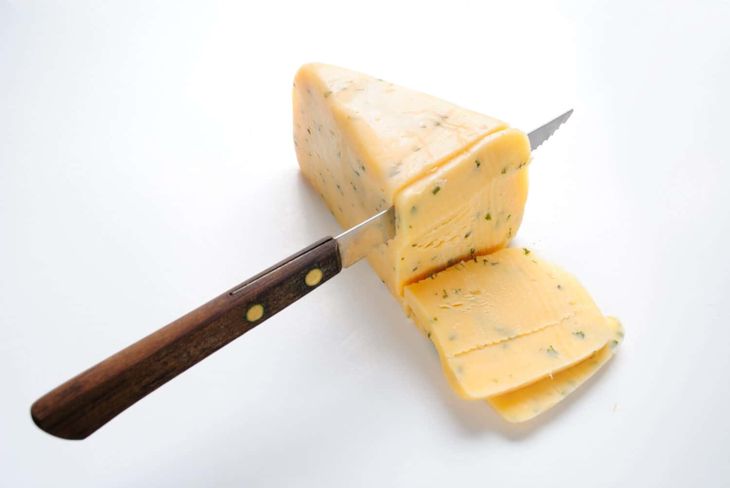 Gloucester cheese with a knife cutting slices.