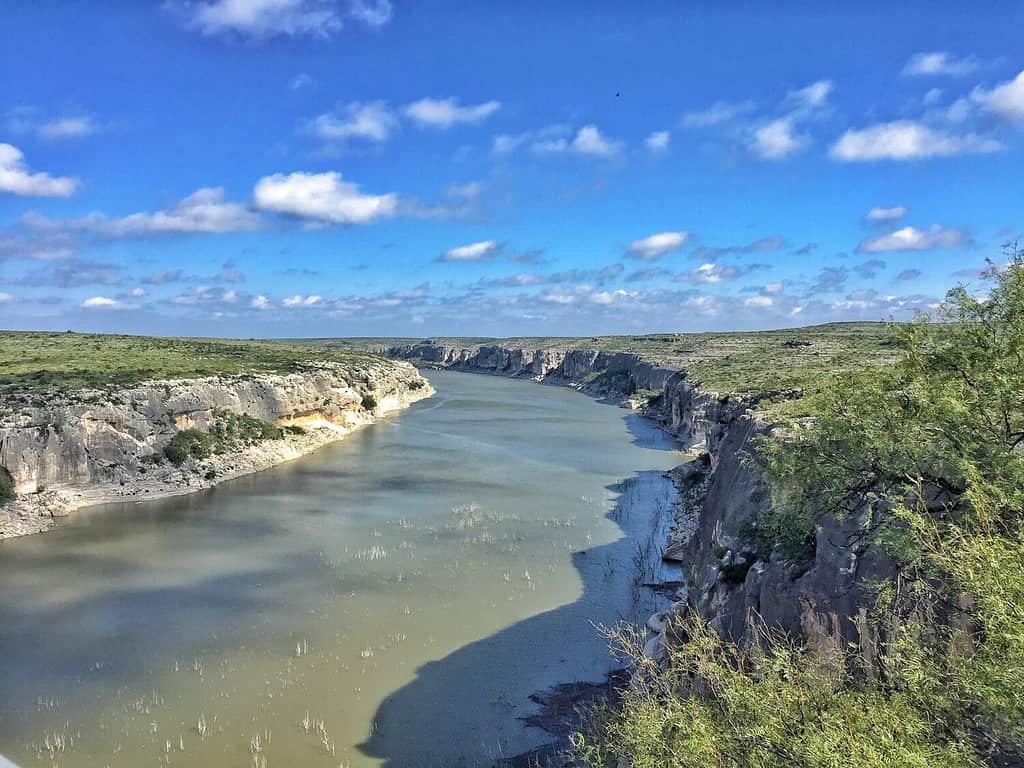Pecos river, taken from the bridge , us 90 , Comstock, TX. Sunny day with blue sky, clouds . October, 2017