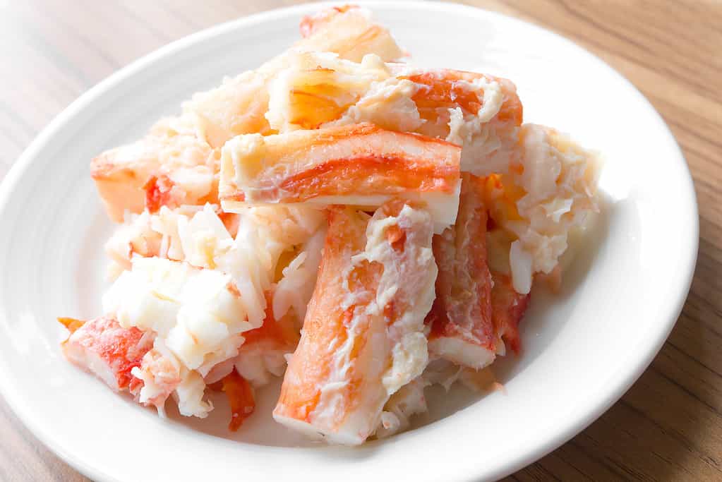 king crab legs meat on white plate