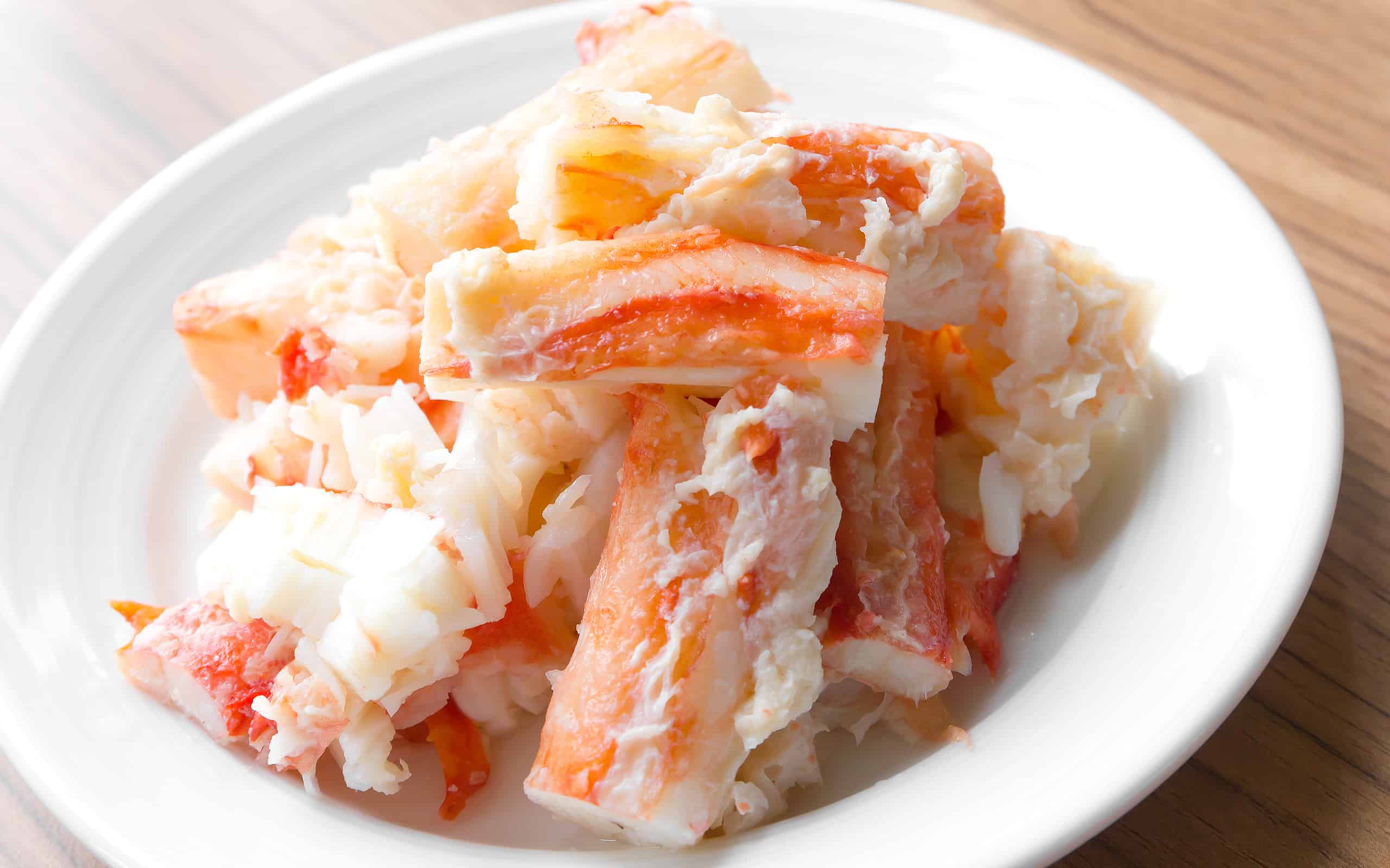 king crab legs meat on white plate