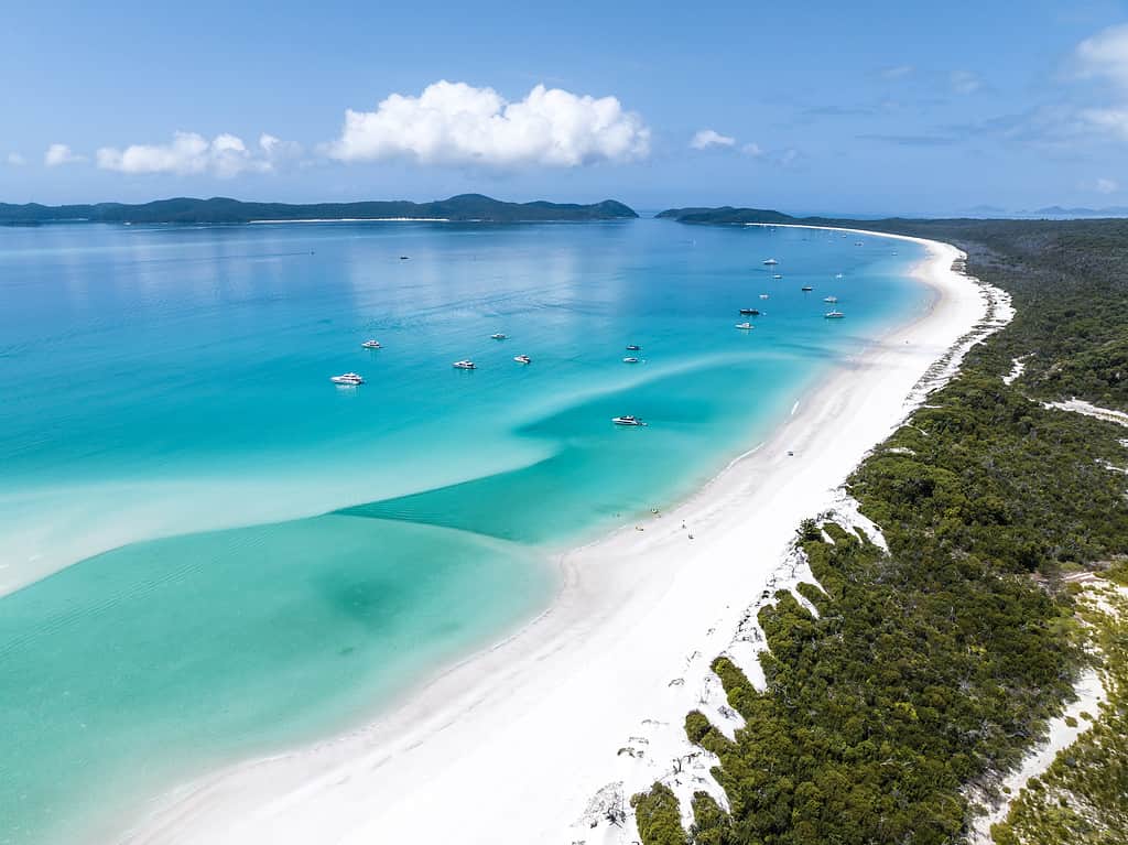 Beautiful high angle aerial drone view of famous Whitehaven Beach, part of the Whitsunday Islands National Park near the Great Barrier Reef, Queensland, Australia. Popular tourist destination.