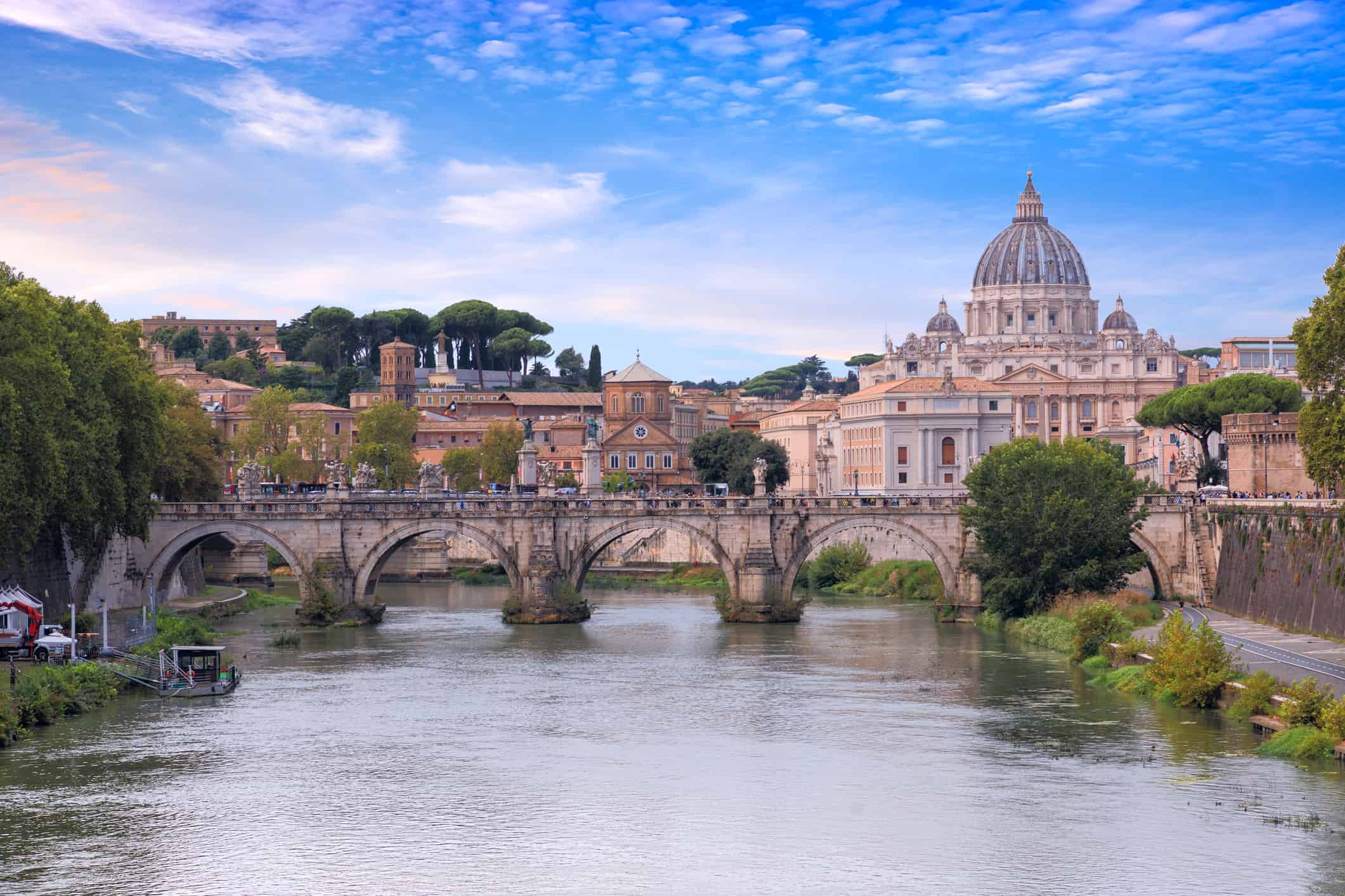 Tiber River in Rome, Italy: view of bridge Ponte Sant'Angelo; on background Saint Peter's Basilica.