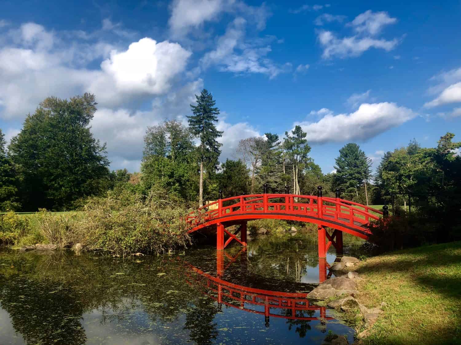 A wooden red oriental bridge in the Meditation Garden located at Duke Farms Wildlife Sanctuary in Hillsborough, New Jersey.