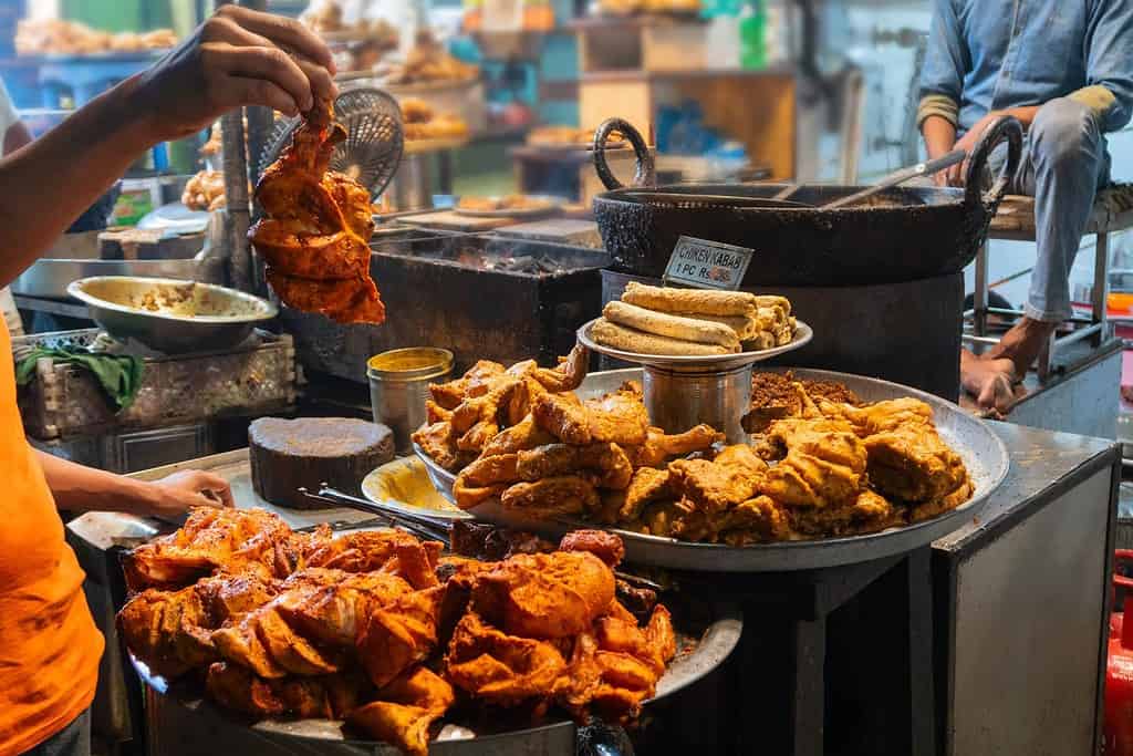 Spicy roasted tandoori chicken , chicken kabab, prepared for sale at evening as street food in Old Delhi market. It is famous for spicy Indian non vegetarian street foods. It is famous tourist spot.