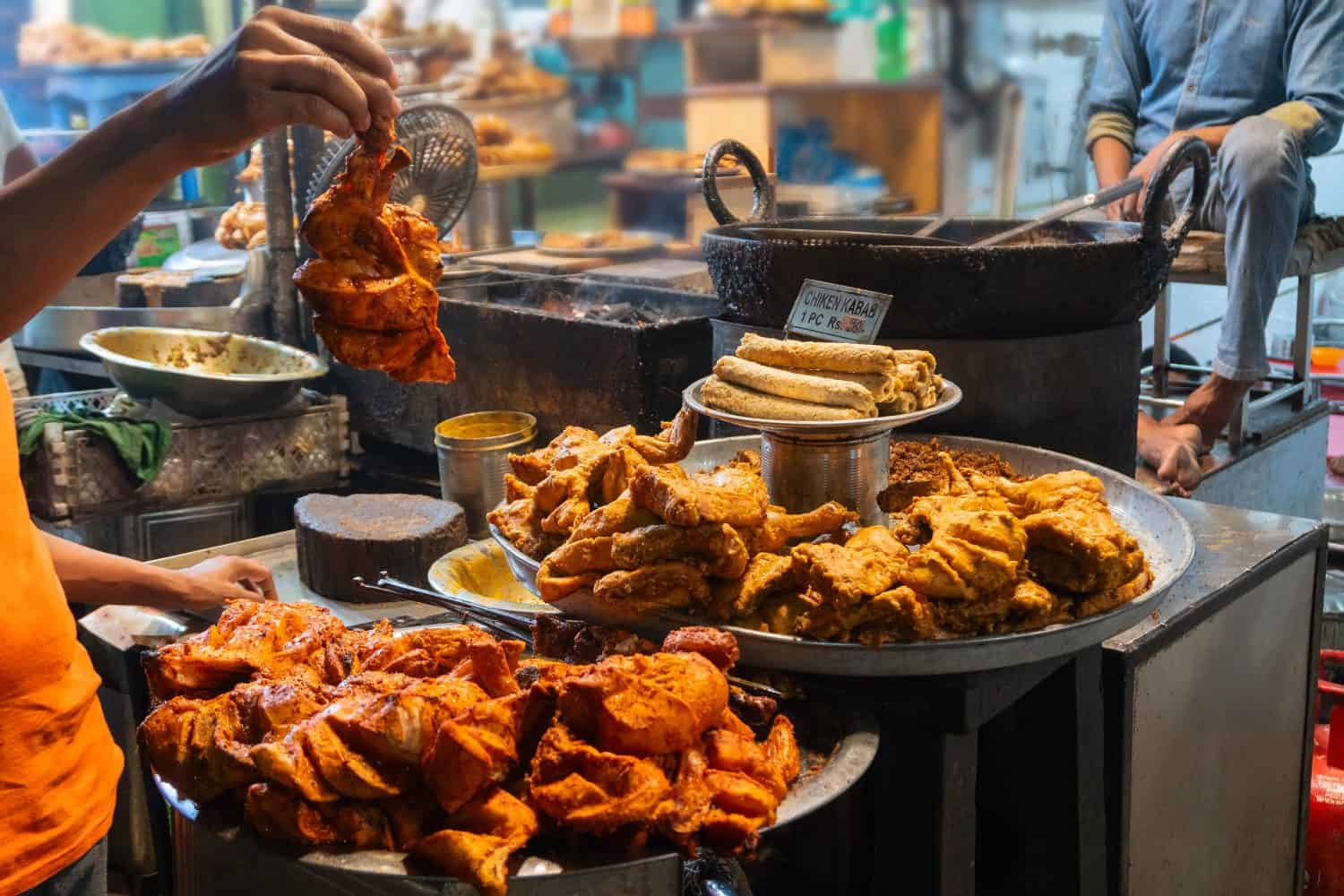 Spicy roasted tandoori chicken , chicken kabab, prepared for sale at evening as street food in Old Delhi market. It is famous for spicy Indian non vegetarian street foods. It is famous tourist spot.