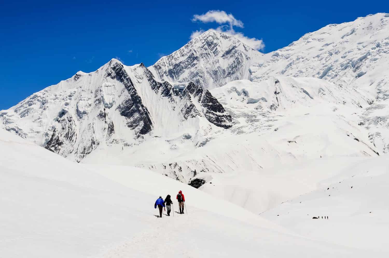 Small group of mountain trekkers in high winter Himalayas mountains, Nepal