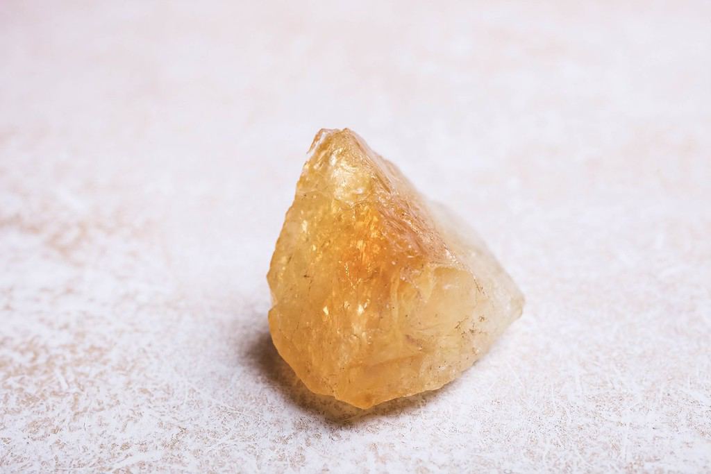 Citrine mineral stone on a white background. The concept of meditation.