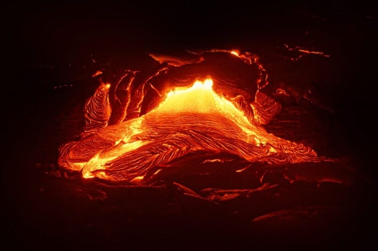 Detailed view of an active lava flow, hot magma emerges from a crack in the earth, the glowing lava appears in strong yellows and reds - Location: Hawaii, Big Island, volcano "Kilauea"