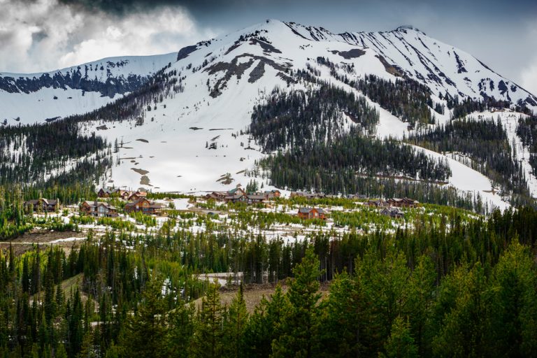 Moonlight Basin ski resort Montana set amongst pine trees and snow capped mountains in the Madison Range of the Rocky Mountains of Big Sky Montana,USA
