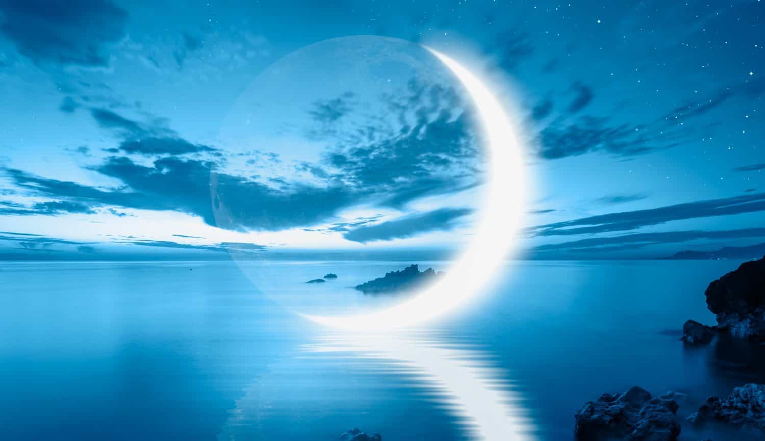 Abstract blue background with crescent moon over the sea,  lot of stars in the background at night 