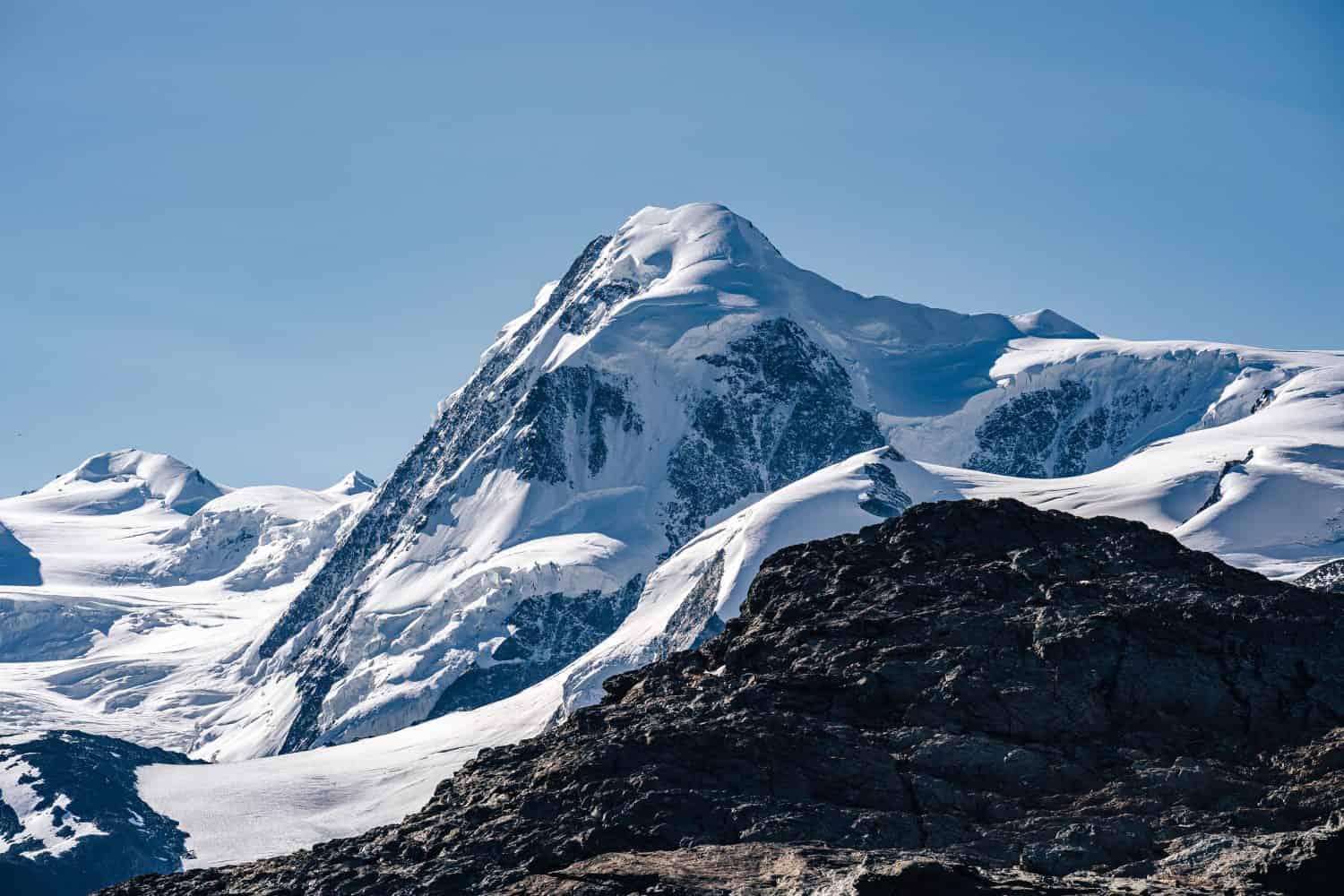 The summit of Liskamm, famous alpine peak above Zermatt, Switzerland. Moutain alpine landscape of Wallis. Snow and ice covered peak, Monte Rosa Glacier.