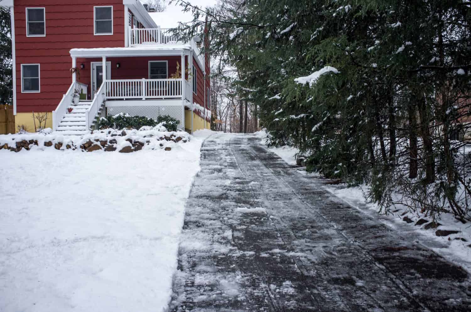 driveway after clean up from the snow, red suburban house in North America