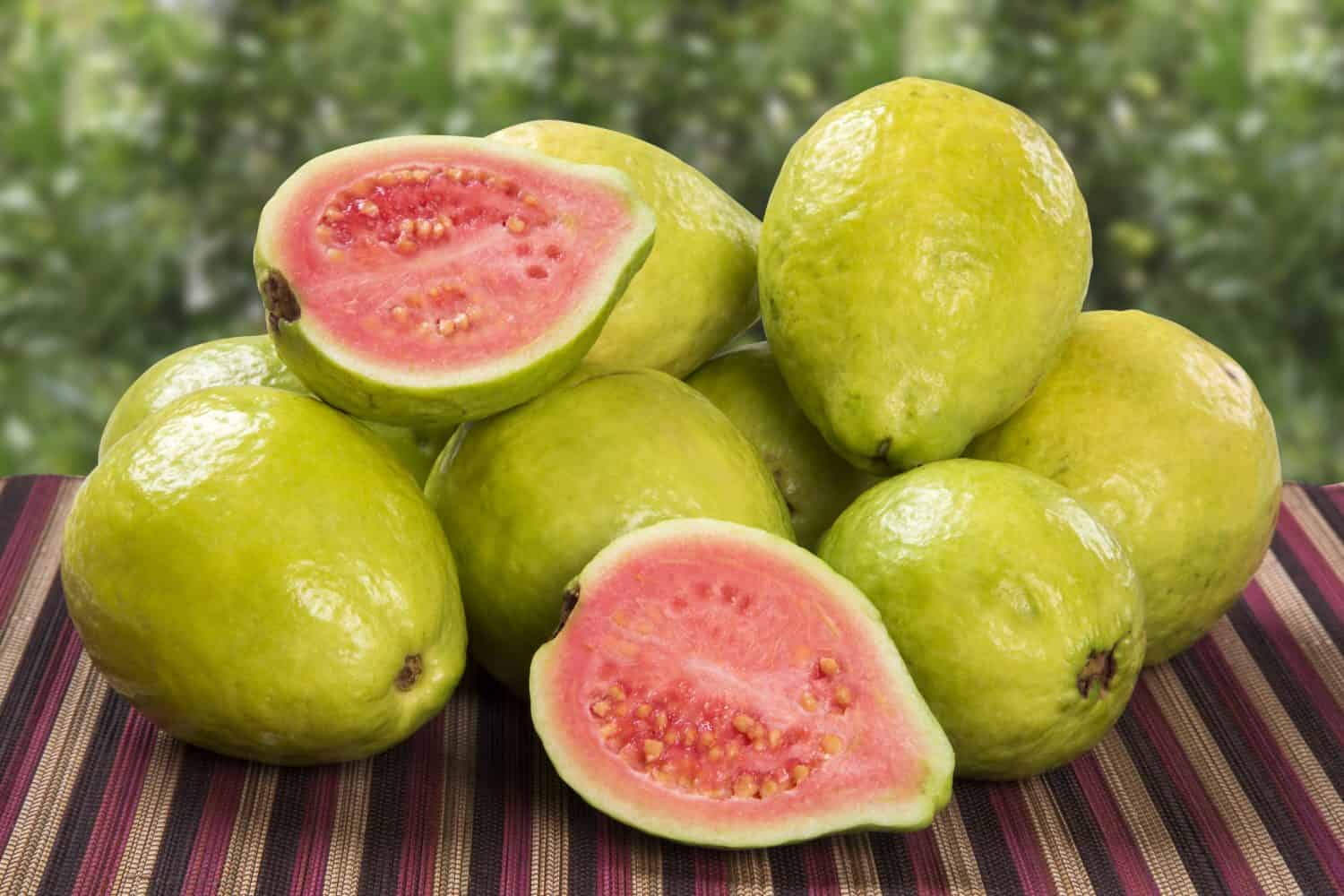 Some brazilian guavas over a striped surface.