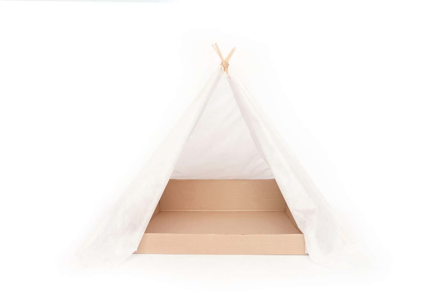 Homemade hut with a box. Teepee for a cat with a paper box on a white background is isolated.