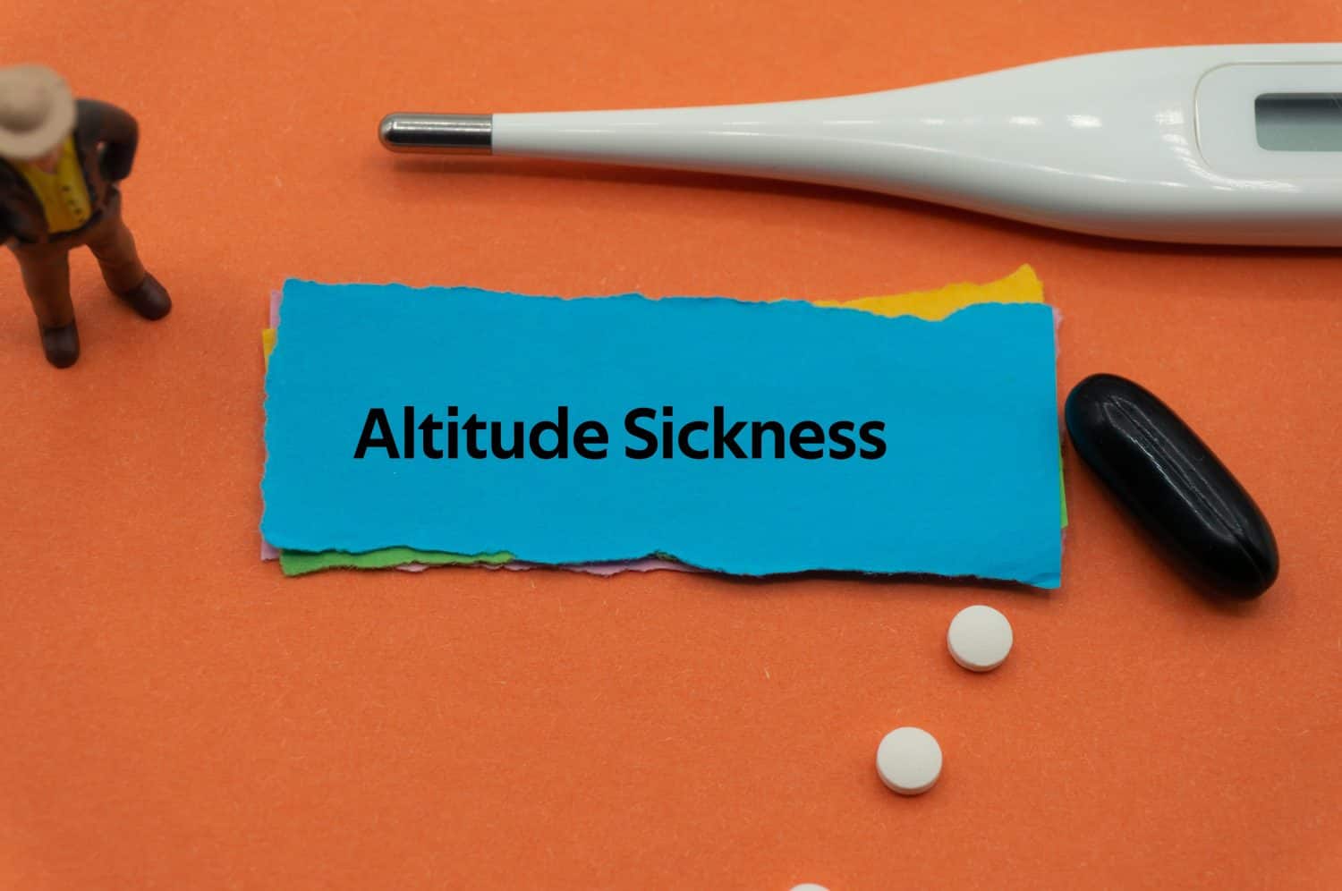 Altitude Sickness.The word is written on a slip of colored paper. health terms, health care words, medical terminology. wellness Buzzwords. disease acronyms.
