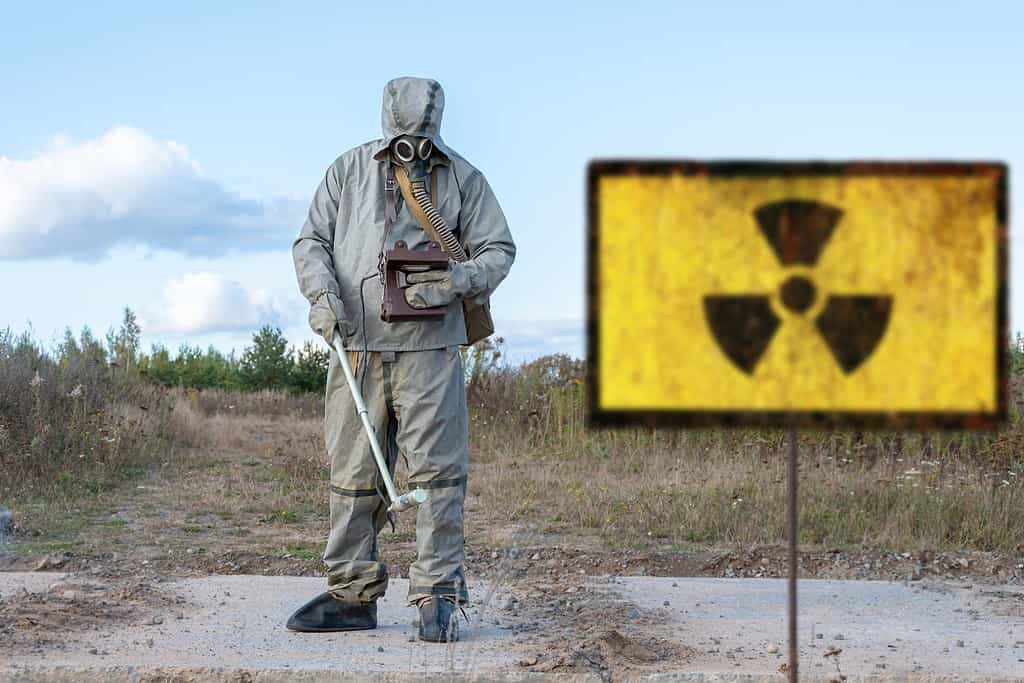 military chemical reconnaissance measures the level of radiation, Old textural Sign of radiation hazard, against the background of infected nature.