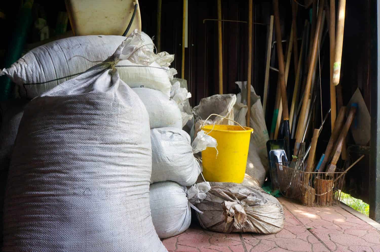 Sackfuls of Fertilizers and Agricultural Tools in Garden Shed. 