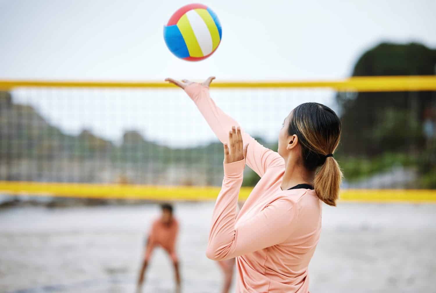 Volleyball, beach or serve of sports women playing a game in training or workout in summer together. Team fitness, freedom or healthy friends on sand ready to start a fun competitive match in Brazil