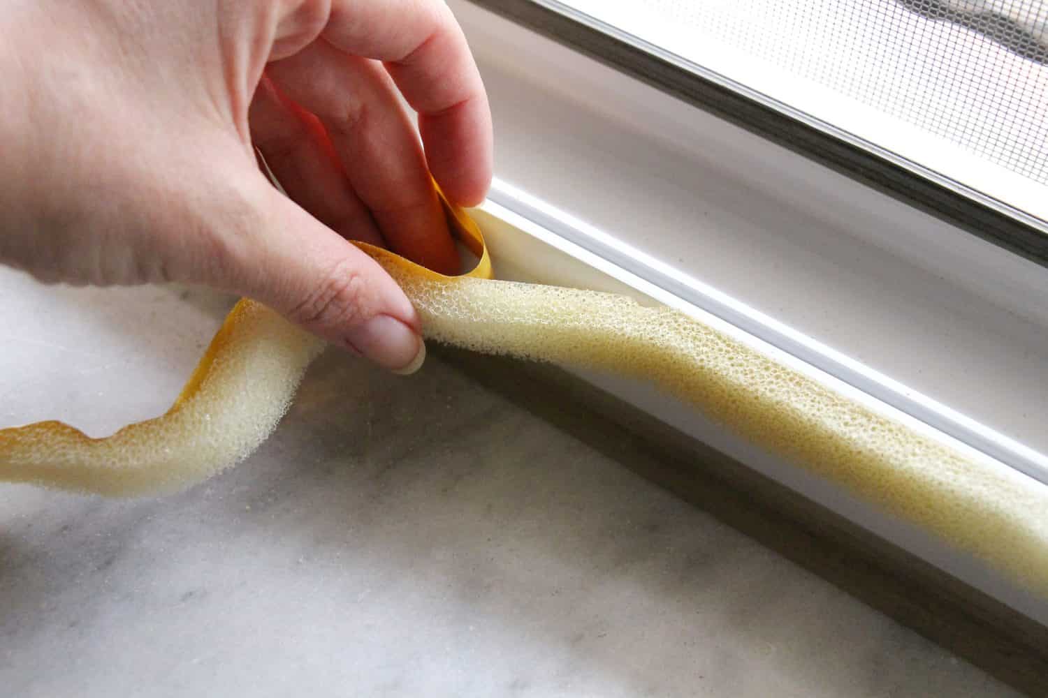 applying sponge tape or window seal to the PVC window for heat insulation