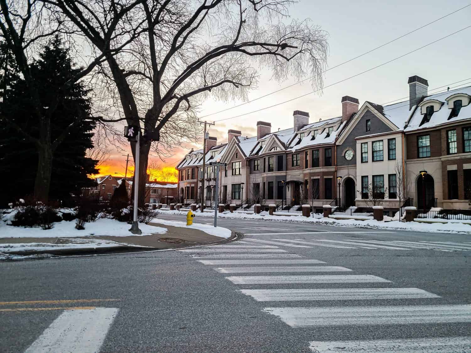 Sunset in the winter in downtown Birmingham, Michigan with townhomes in the foreground, Ice Skating Rinks in Michigan