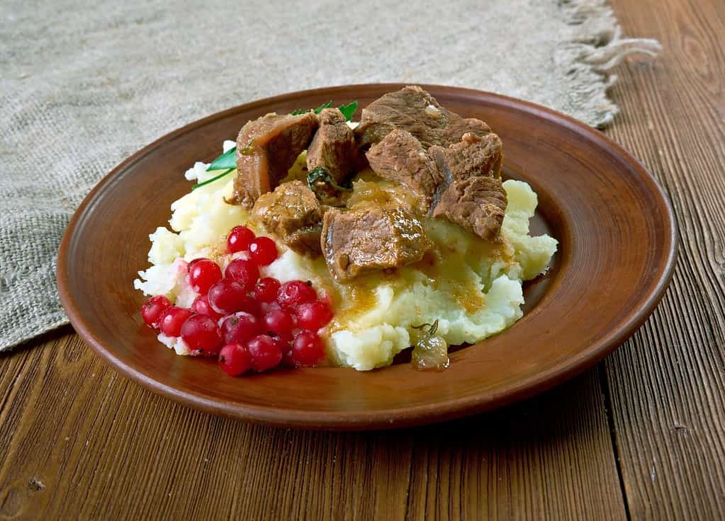 Sauteed reindeer venison steak served with mashed potatoes and lingonberry - traditional meal from Lapland, especially in Finland, Sweden, Norway and Russia.