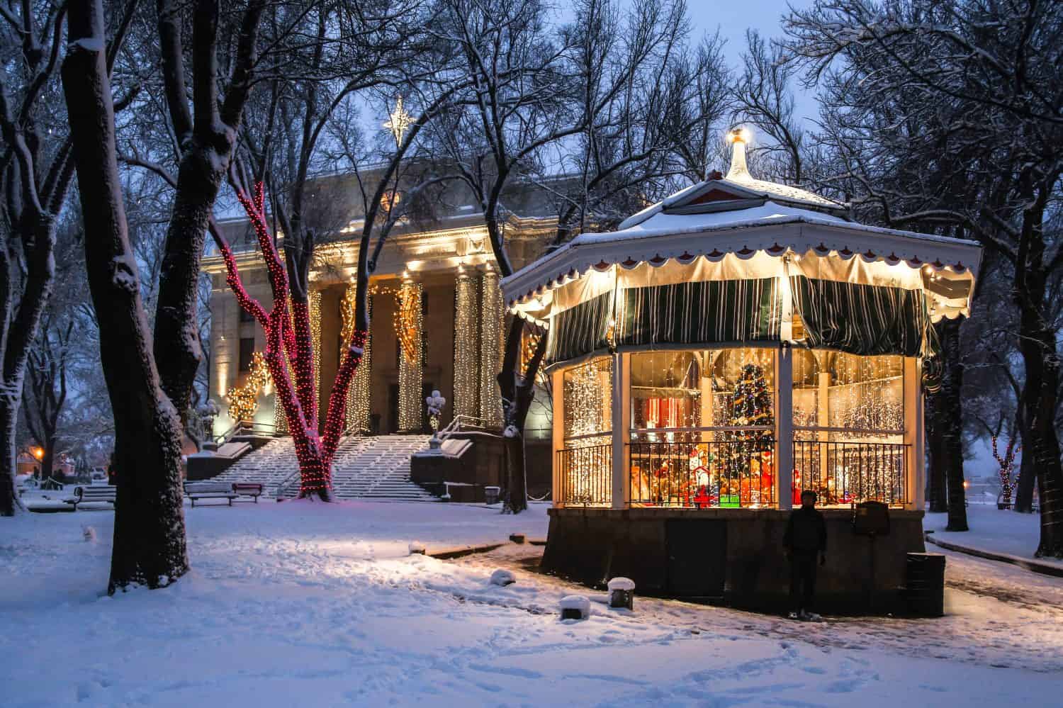 Holiday lights in the fresh snow around decorated gazebo at the Yavapai County Courthouse in Prescott, Arizona