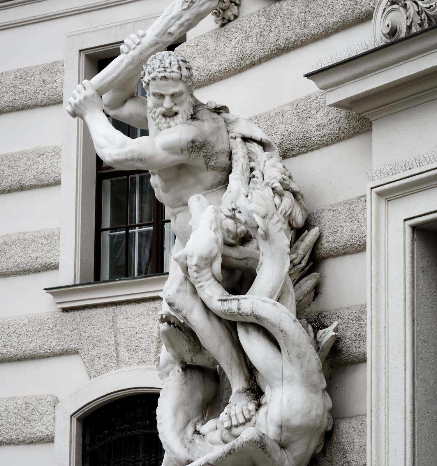 Statue of Heracles defeating the lernaean hydra in Vienna, detail of Hofburg imperial palace facade from Michaelerplatz square