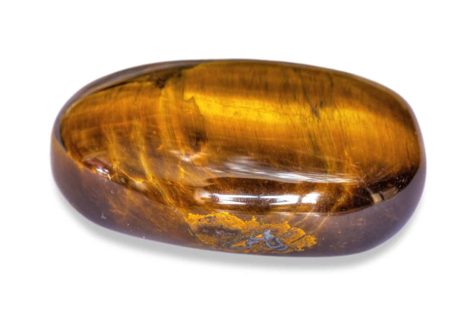 The semi-precious stone Tiger's Eye, polished, on a white background.