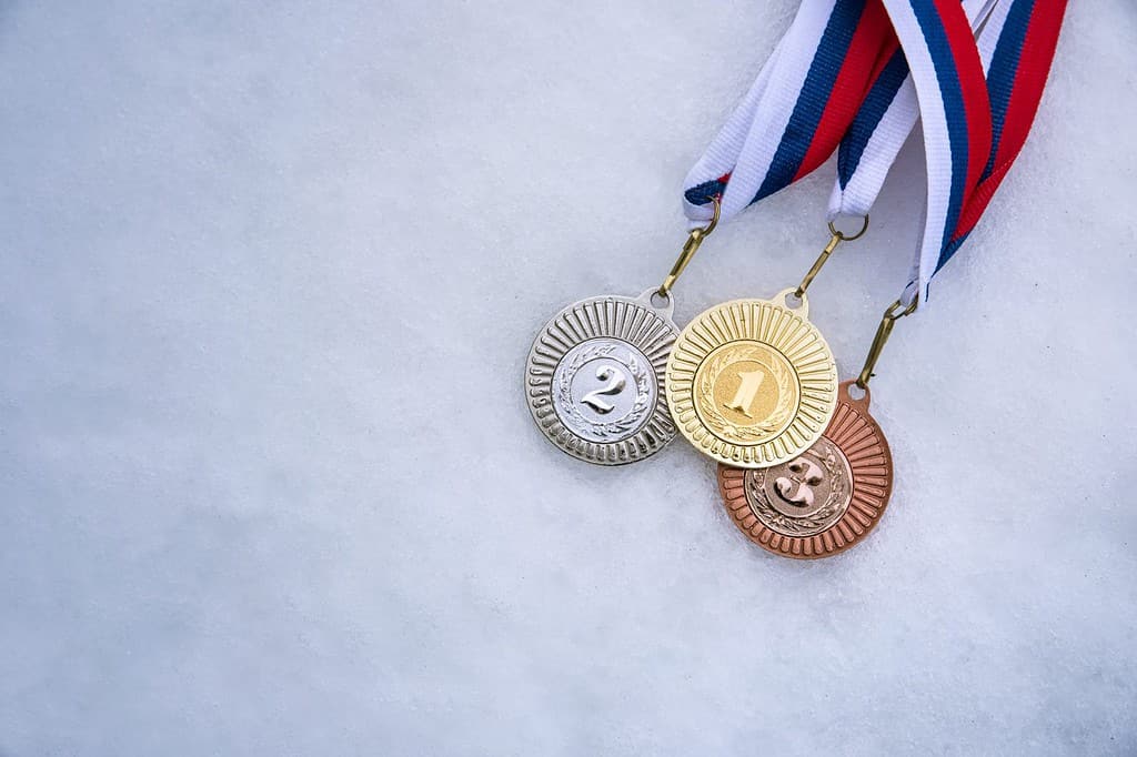 Gold silver and bronze medal, white snow background. Winter sport trophy for ski, hockey, nordic ski. Picture for winter olympic game in pyeongchang 2018