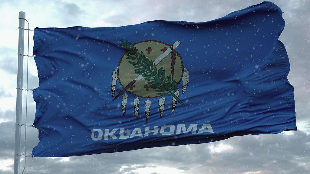 Oklahoma winter flag with snowflakes background. United States of America. 3d rendering