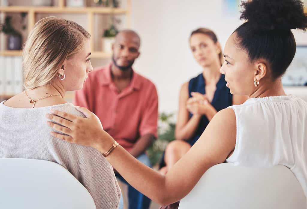 Psychology, mental health and support group with a woman in counseling for help with depression and anxiety with a psychologist she can trust. Communication, community or counselor with a sad patient