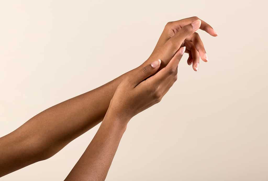 Gentle black female hands with natural manicure